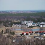 Explore Birštonas, Lithuania's mix of modern buildings and lush greenery from an aerial perspective.